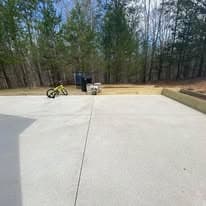 Empty outdoor space with a bike and trash can surrounded by trees.